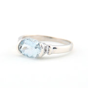 Silver ring with a blue gemstone on a white background