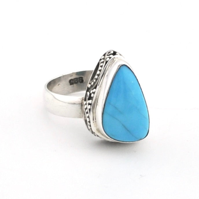 Silver ring with turquoise on white background.