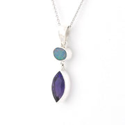 Silver necklace with two gemstones on a white background