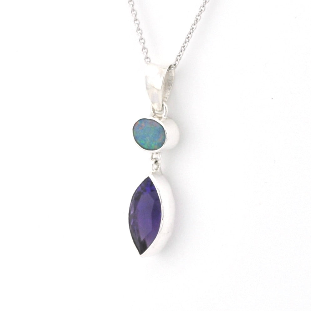 Silver necklace with two gemstones on a white background
