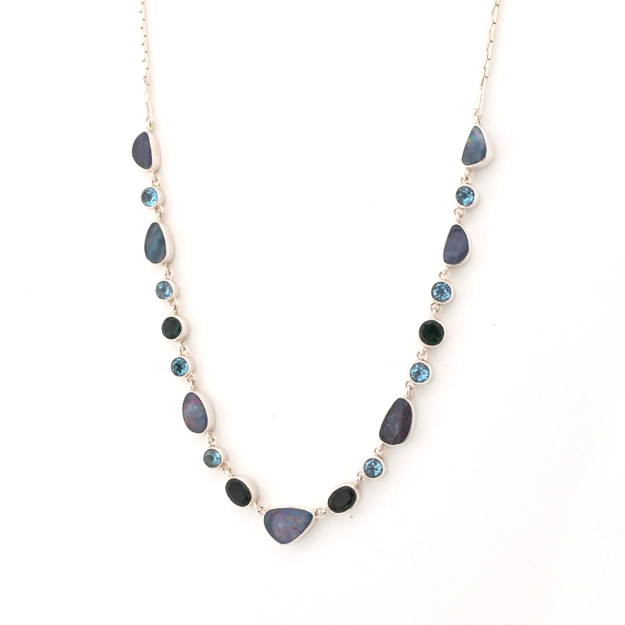 Necklace with opals, blue topaz and green quartz stones on a white background