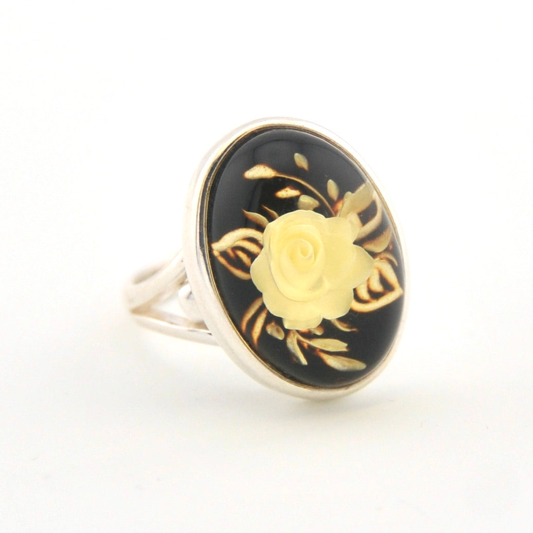 Ring with gold rose design on a black background