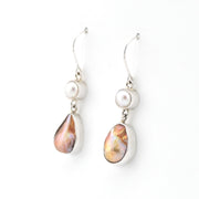 Pair of earrings with pearl and teardrop-shaped gemstone on a white background
