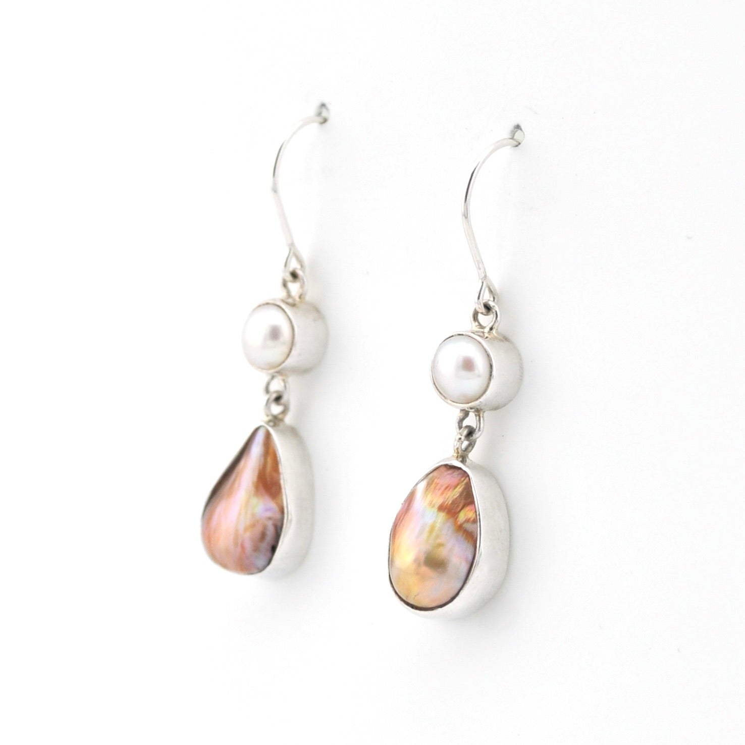 Pair of earrings with pearl and teardrop-shaped gemstone on a white background