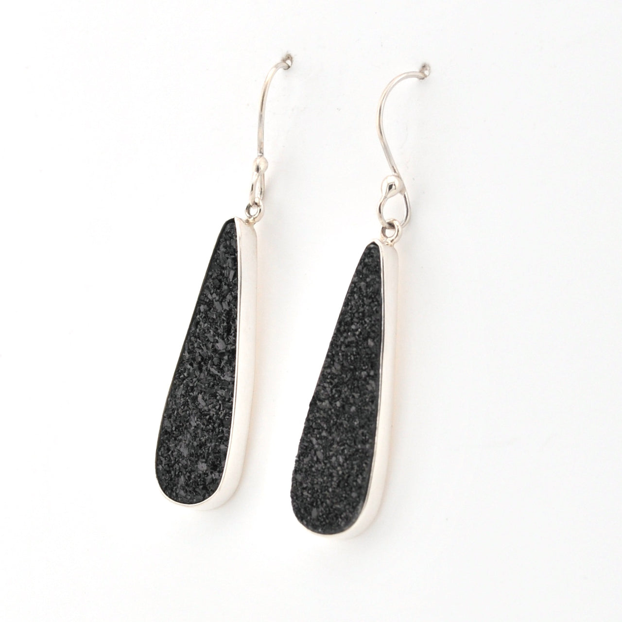Black teardrop earrings with silver hooks on a white background