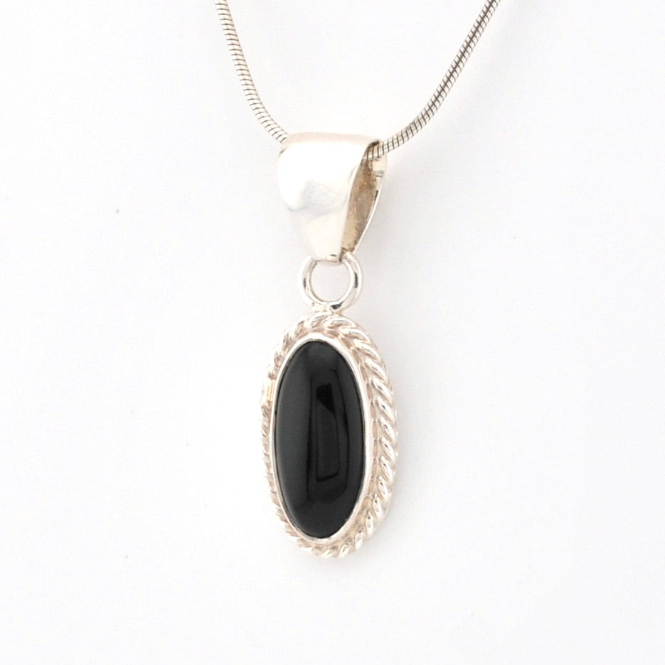 Black oval pendant on a silver chain against a white background