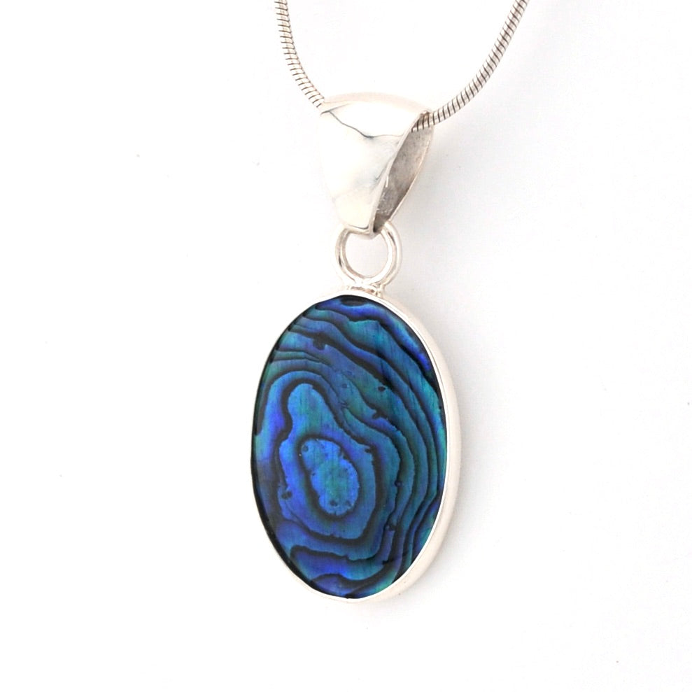 Oval pendant with blue and green patterns on a white background