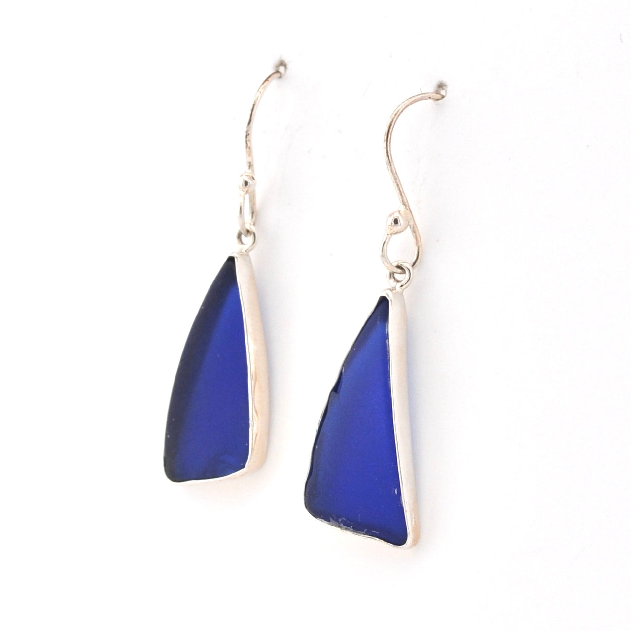 Blue triangular earrings with silver hooks on a white background