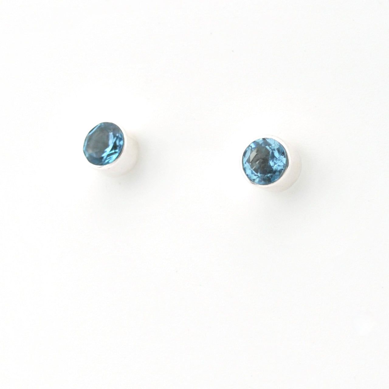 Two blue gemstones on a white background