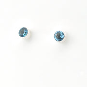 Two blue gemstones on a white background