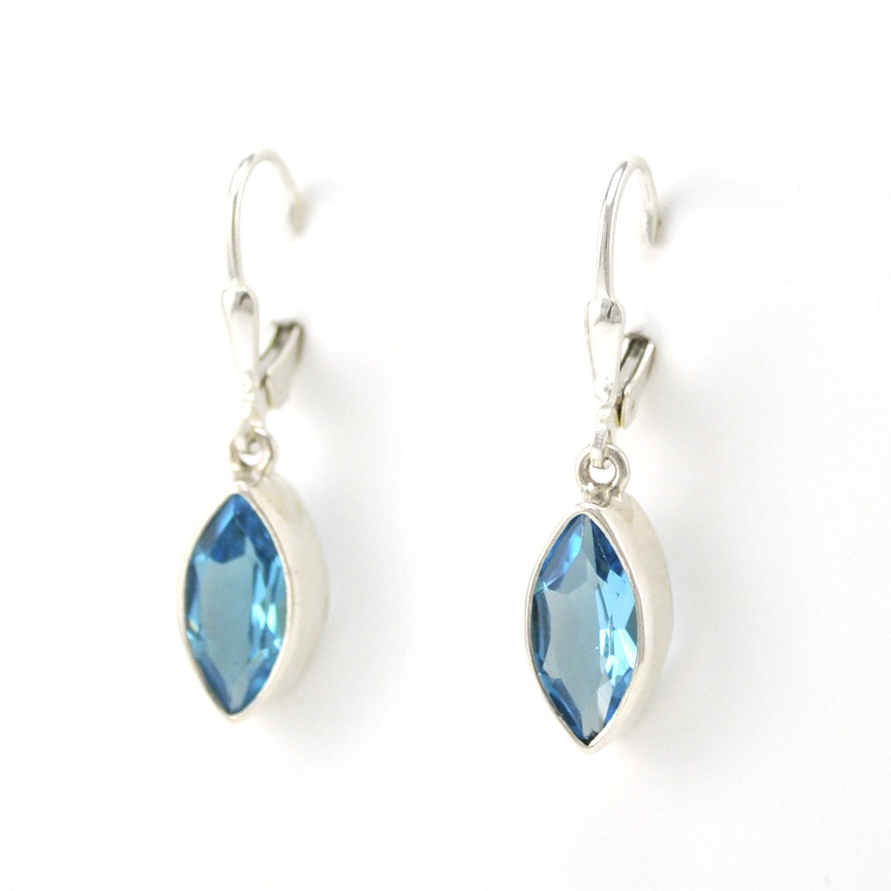 Blue topaz marquise earrings on white background.