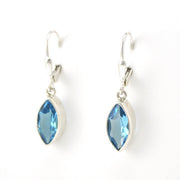 Blue topaz marquise earrings on white background.