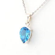 Blue teardrop pendant on a white background