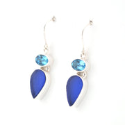 Pair of blue teardrop earrings with gemstones on a white background