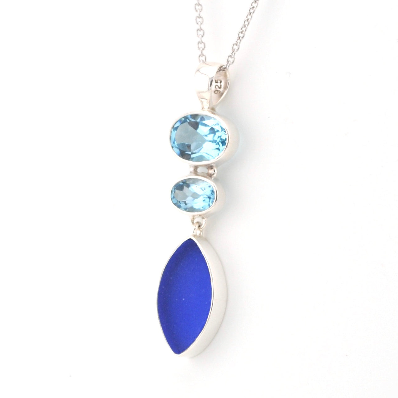 Necklace with blue topaz and sea glass pendant on a white background