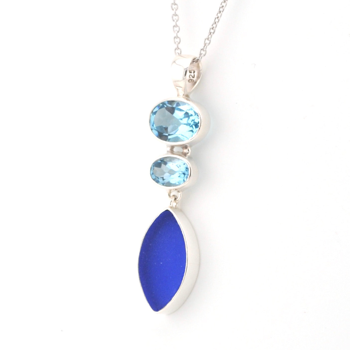 Necklace with blue topaz and sea glass pendant on a white background