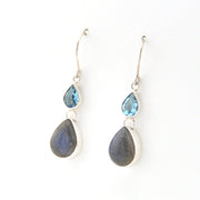 Pair of earrings with teardrop-shaped stones on a white background