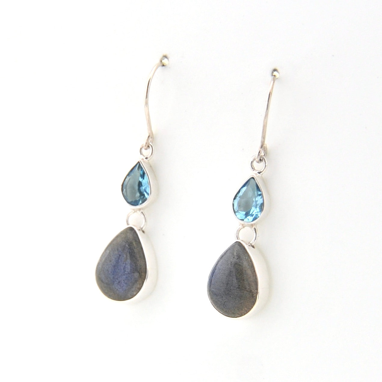 Pair of earrings with teardrop-shaped stones on a white background