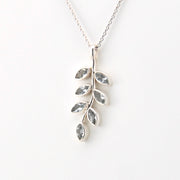 Silver leaf-shaped pendant necklace on a white background
