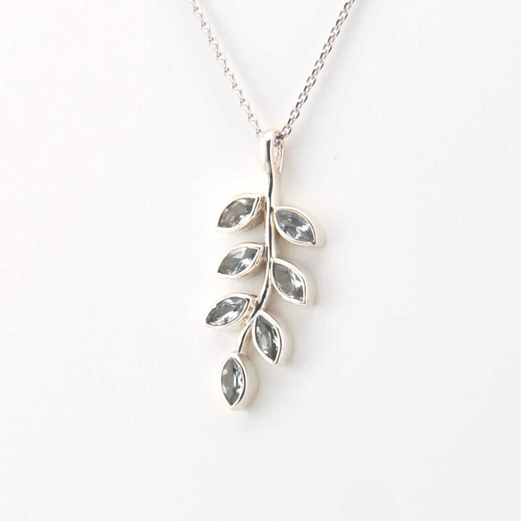 Silver leaf-shaped pendant necklace on a white background