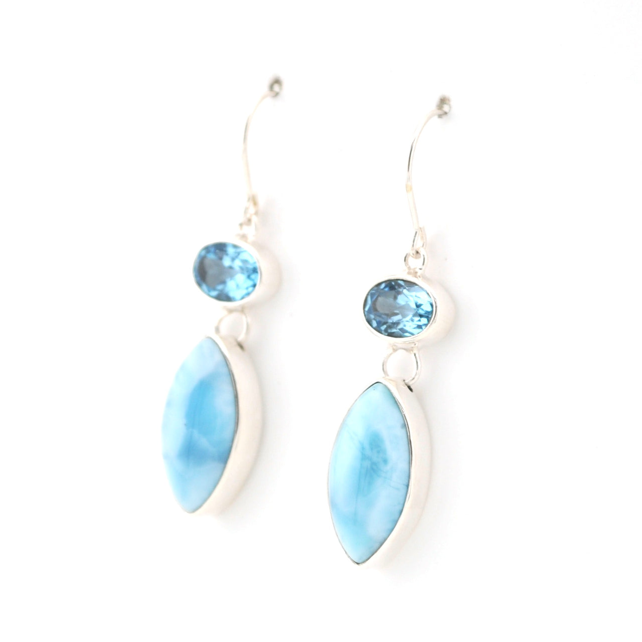 Pair of earrings with blue stones and light blue marquise-shaped stones on a white background