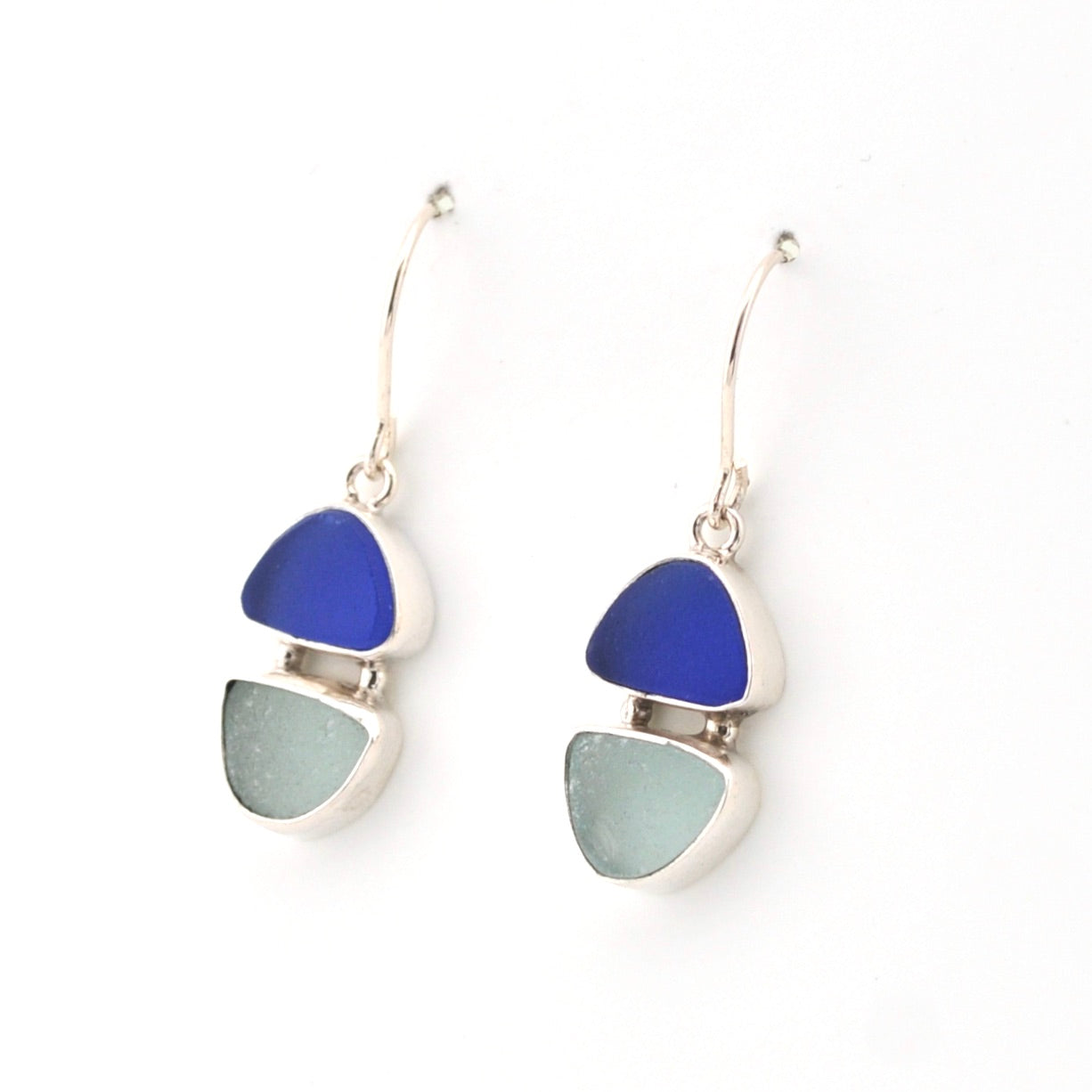 Pair of earrings with blue and green triangular stones on a white background