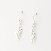 Silver leaf-shaped earrings on a white background