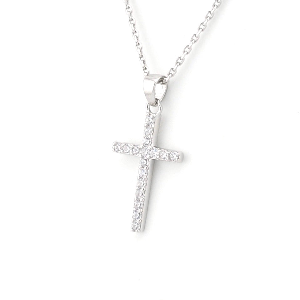 Silver cross necklace on a white background