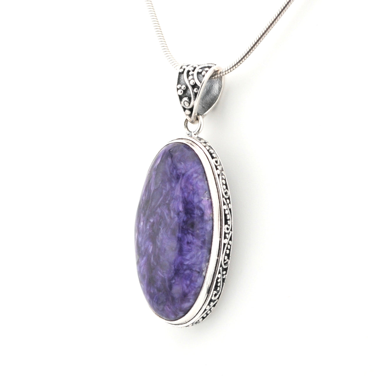 Purple pendant with silver frame on a white background