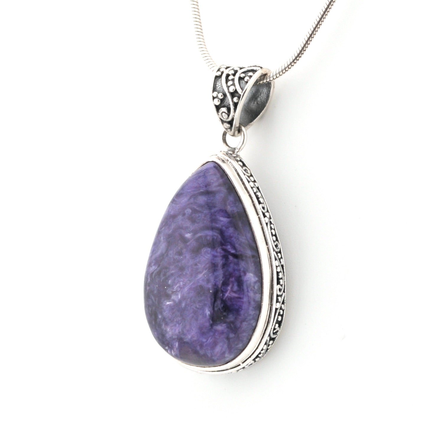 Purple teardrop pendant with silver frame on a white background
