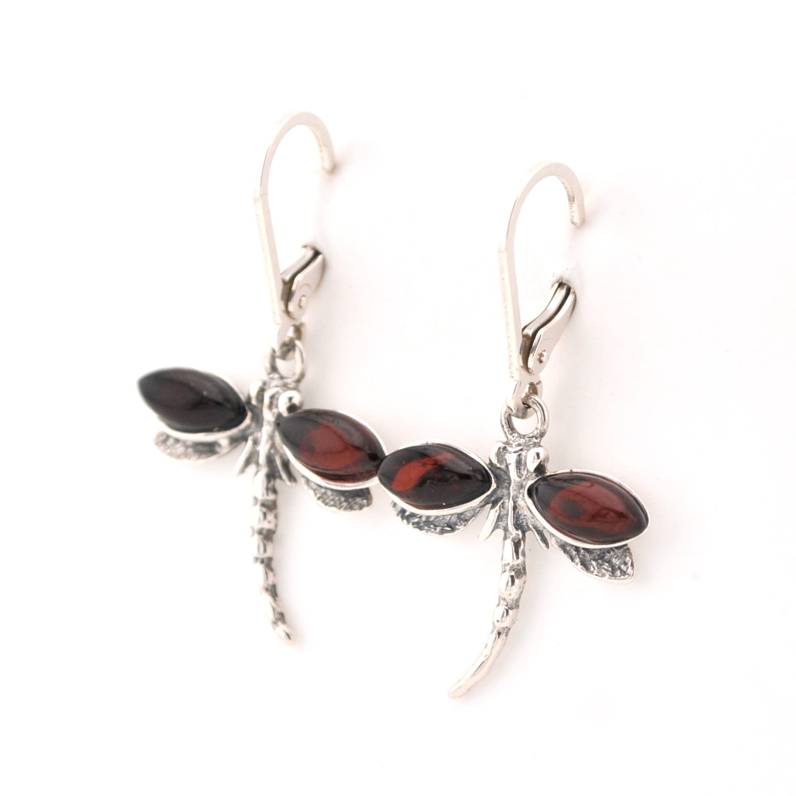 Silver earrings with red gemstones on a white background
