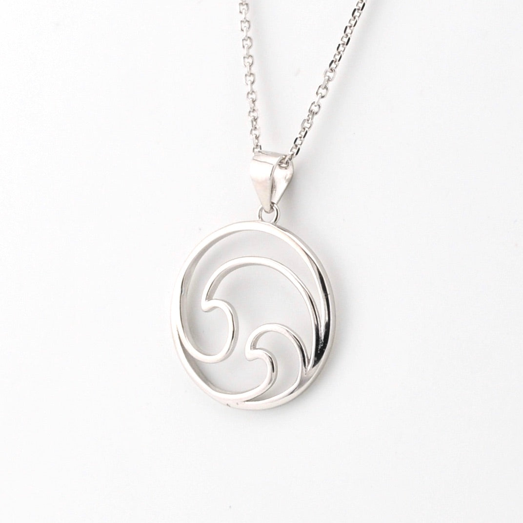 Silver necklace with a circular pendant on a white background