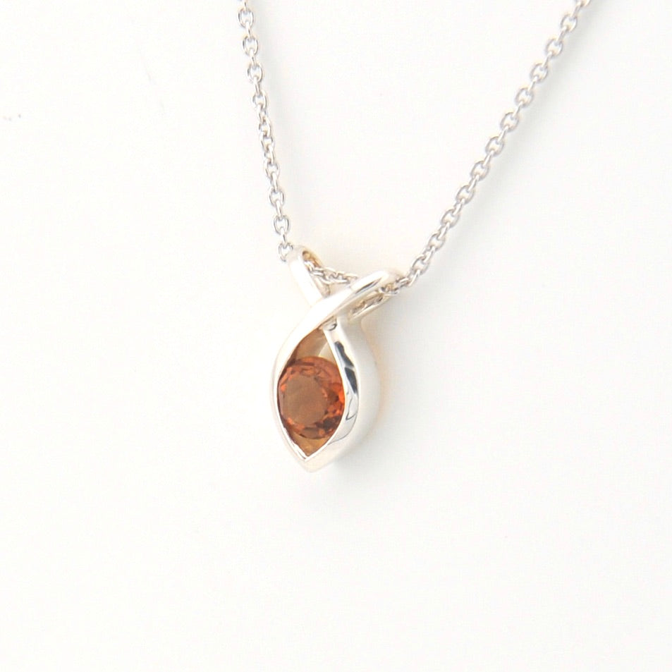 Marquise-shaped pendant with a brown gemstone on a white background