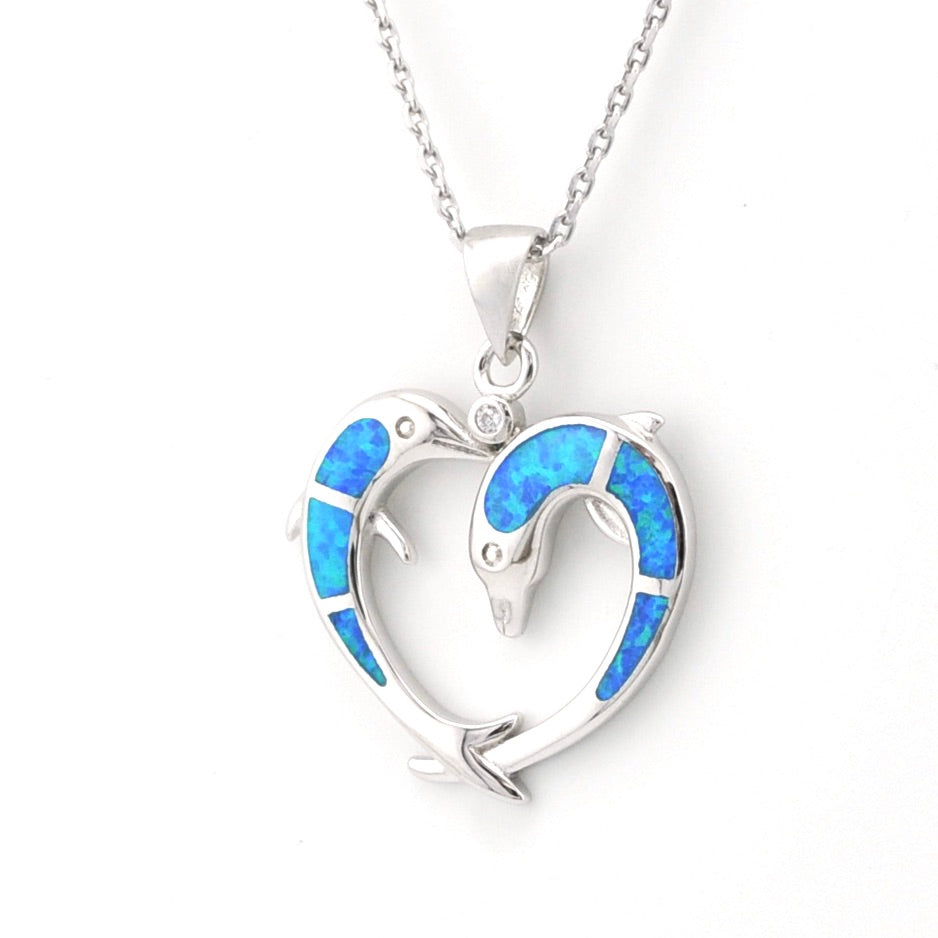 Heart-shaped pendant with blue opal inlay on a white background
