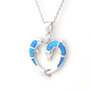 Heart-shaped pendant with blue opal inlay on a white background