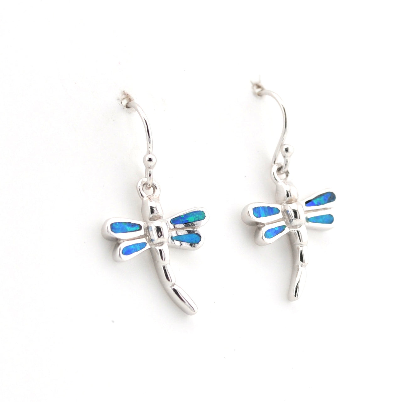 Dragonfly-shaped earrings with blue accents on a white background