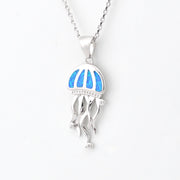 Silver jellyfish pendant with blue opal on a white background