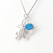 Silver pendant with a blue opal stone on a white background