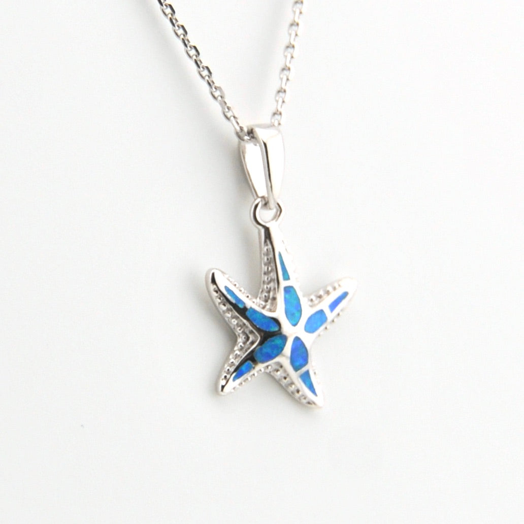 Starfish-shaped pendant with blue center on a white background