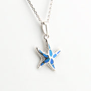 Starfish-shaped pendant with blue center on a white background