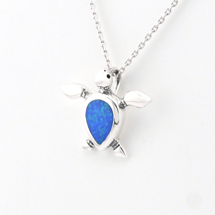 Silver pendant with a blue opal stone on a white background