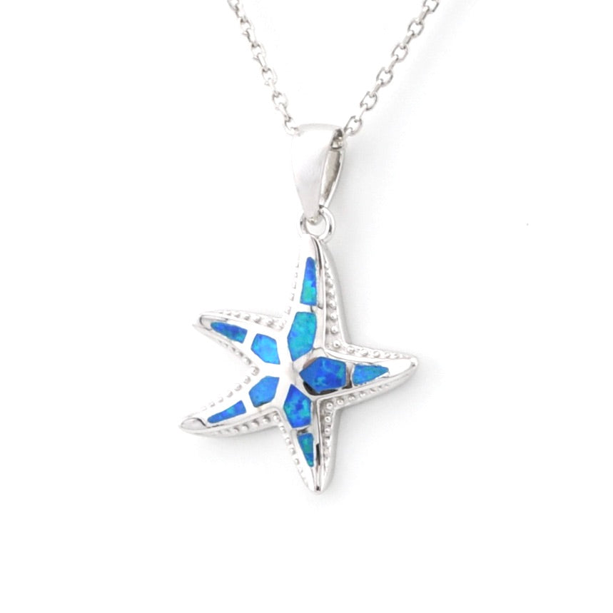 Starfish-shaped pendant with blue inlay on a white background