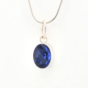 Blue gemstone pendant on a white background
