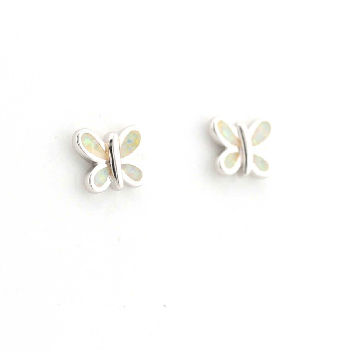 Butterfly-shaped earrings with opal-like centers on a white background