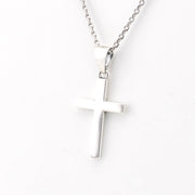 Silver cross pendant on a chain against a white background