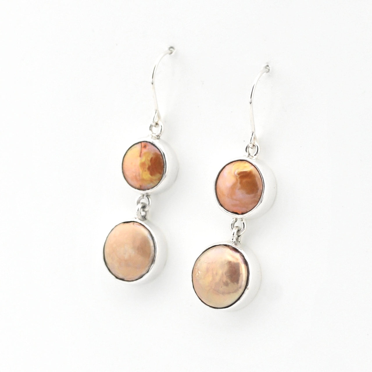 Pair of earrings with round, multicolored stones on a white background