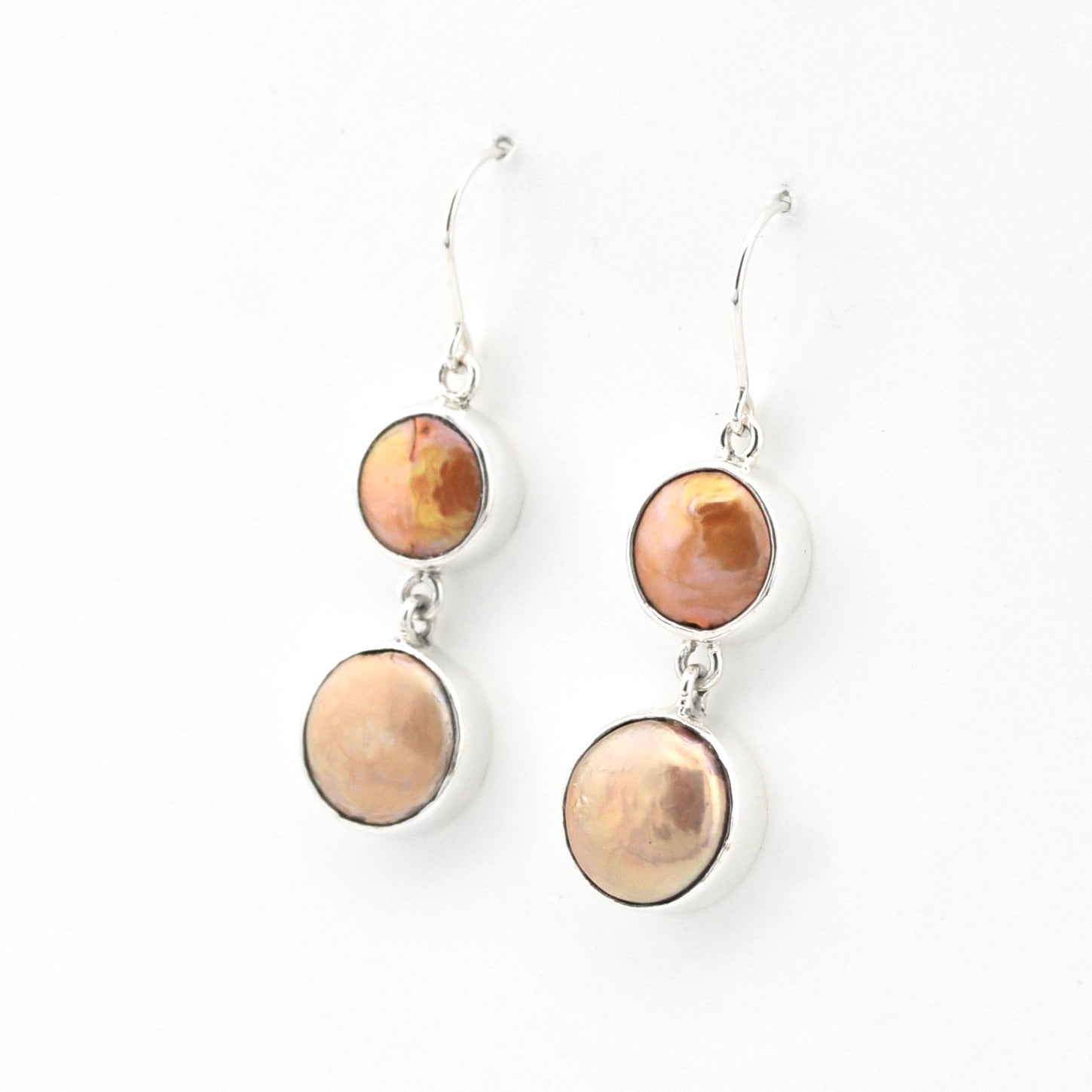 Pair of earrings with round, multicolored stones on a white background