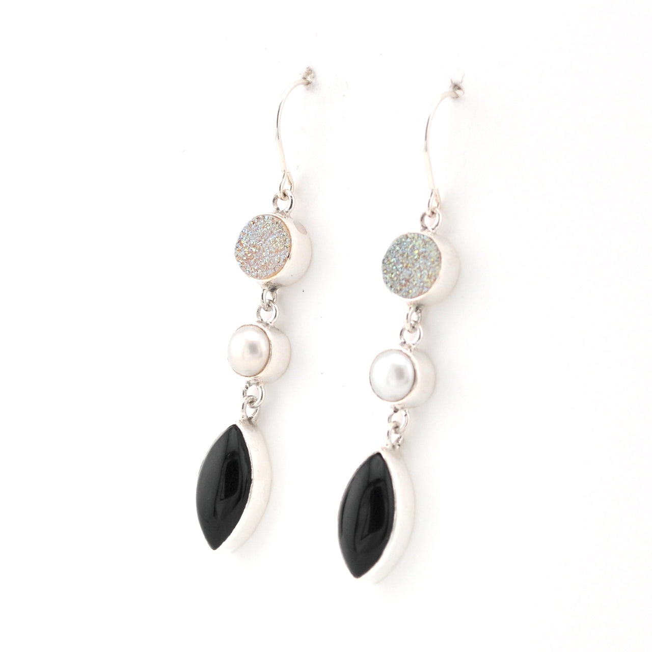 Pair of earrings with black, white, and gray stones on a white background