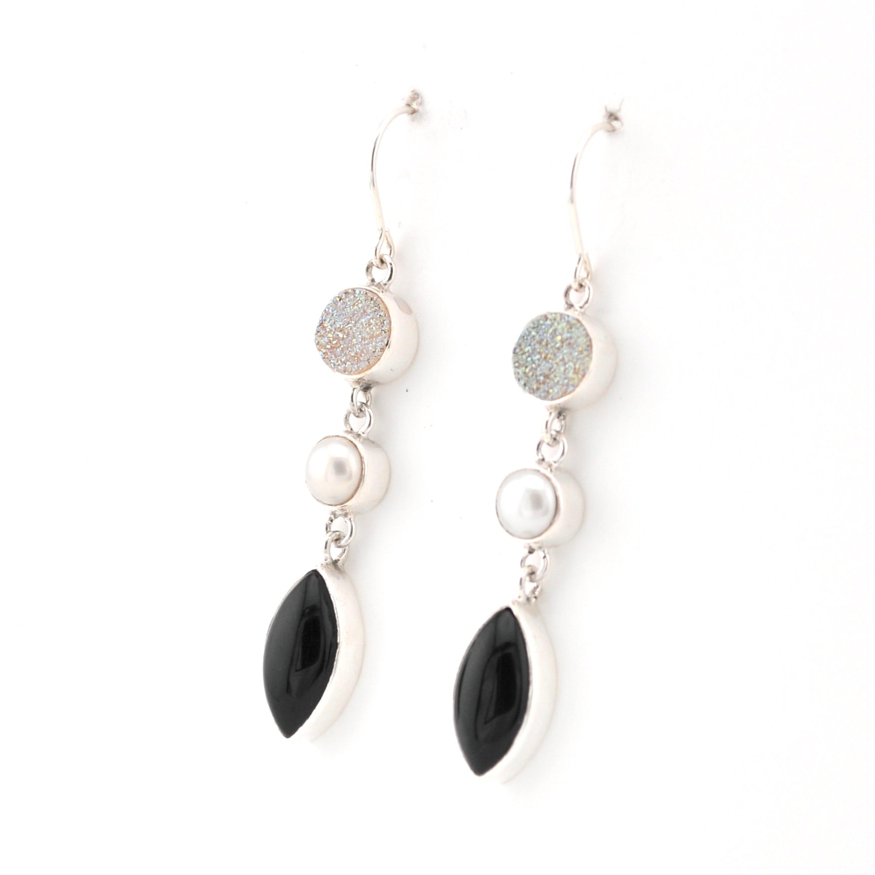 Pair of earrings with black, white, and gray stones on a white background