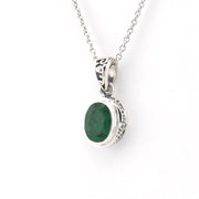 Silver necklace with a green gemstone pendant on a white background